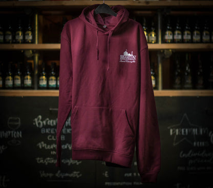 Maroon hoodie with a Brampton Brewery logo on a hanger against a backdrop of bottles